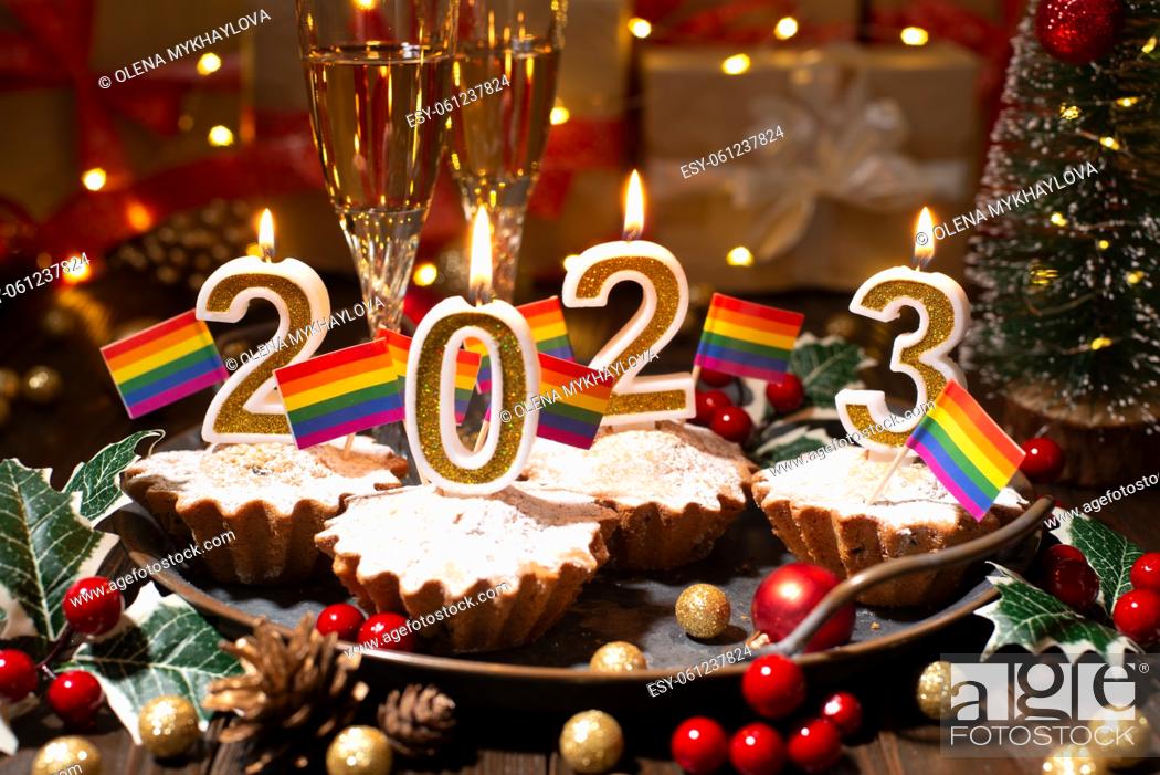 Photo de stock: Food tray with cupcakes new year candles wineglasses and gay flags decorations.