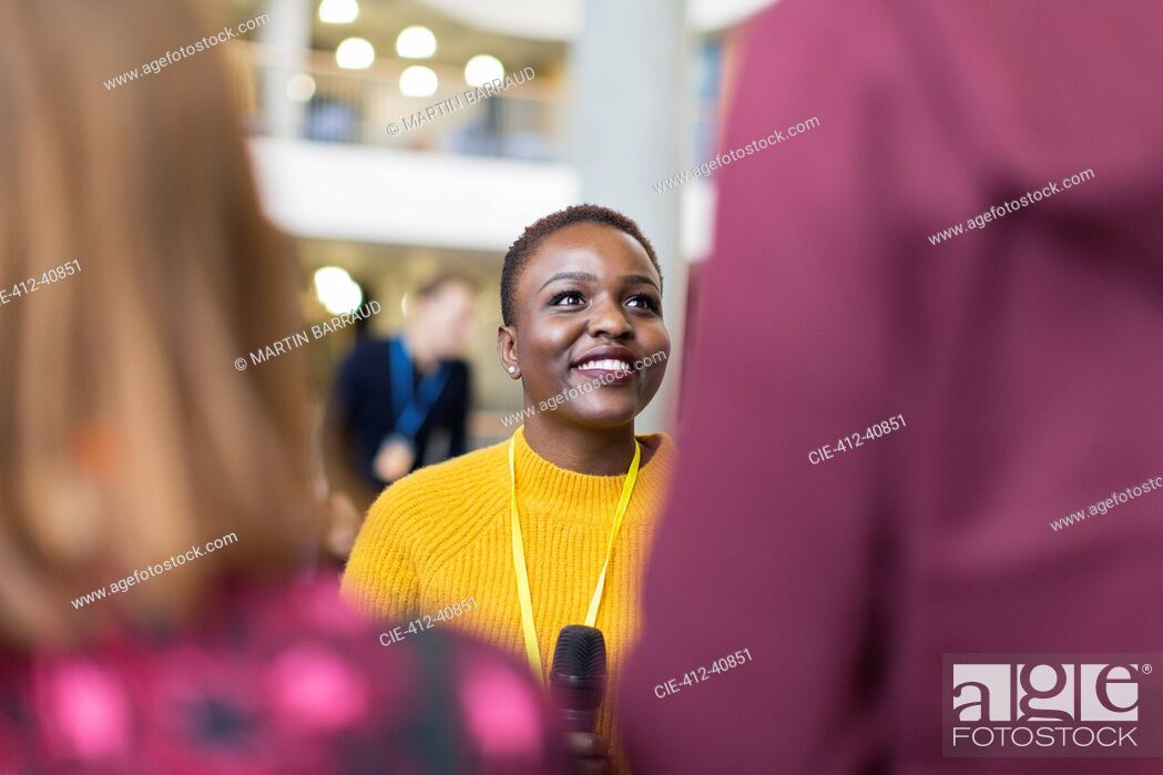 Stock Photo: Smiling female speaker talking to audience.