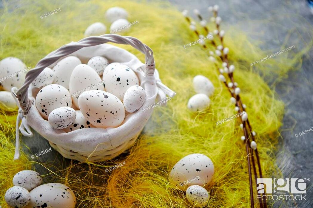 Stock Photo: Easter white dotted Eggs in the nest and spring yellow grass on stone table background.