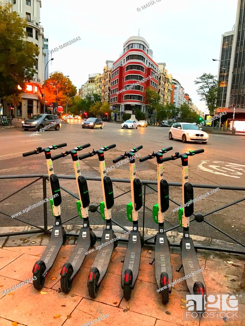 Stock Photo: Hire electric scooters. Goya street, Madrid, Spain.