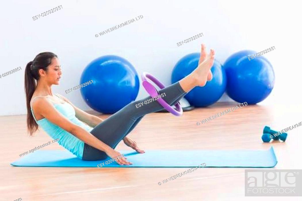 Stock Photo: Sporty woman with exercising ring in fitness studio.
