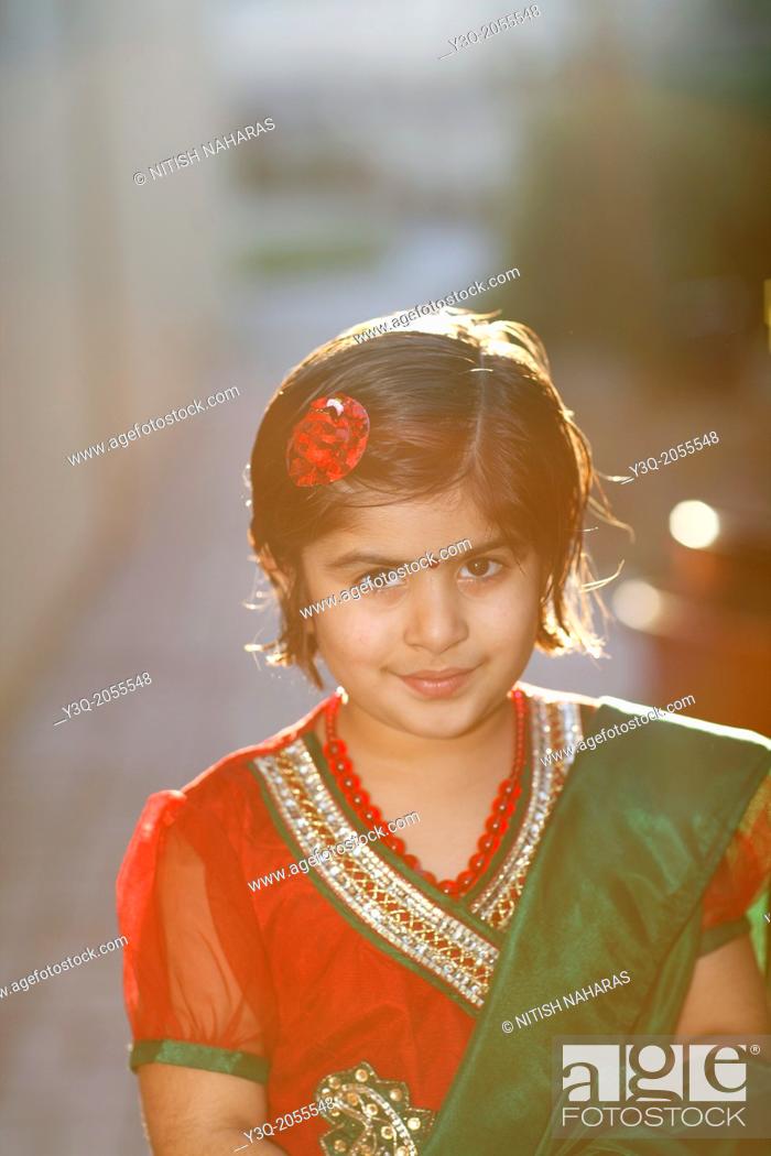 Stock Photo: Portrait of an indian american girl playing outdoors.
