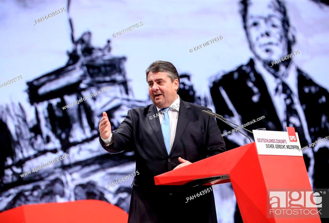 Stock Photo: Sigmar Gabriel, SPD chairman and German economy minister, delivers a speech in front of an image of former German Chancellor Willy Brandt at the national.