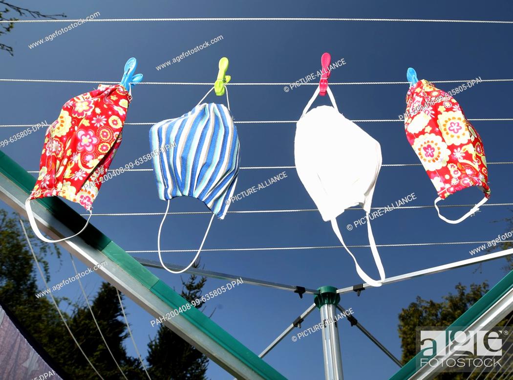Stock Photo: 08 April 2020, North Rhine-Westphalia, Mülheim: The 79-year-old pensioner Inge Vincents has hung up her self-sewn masks to dry after 60 degrees washing.