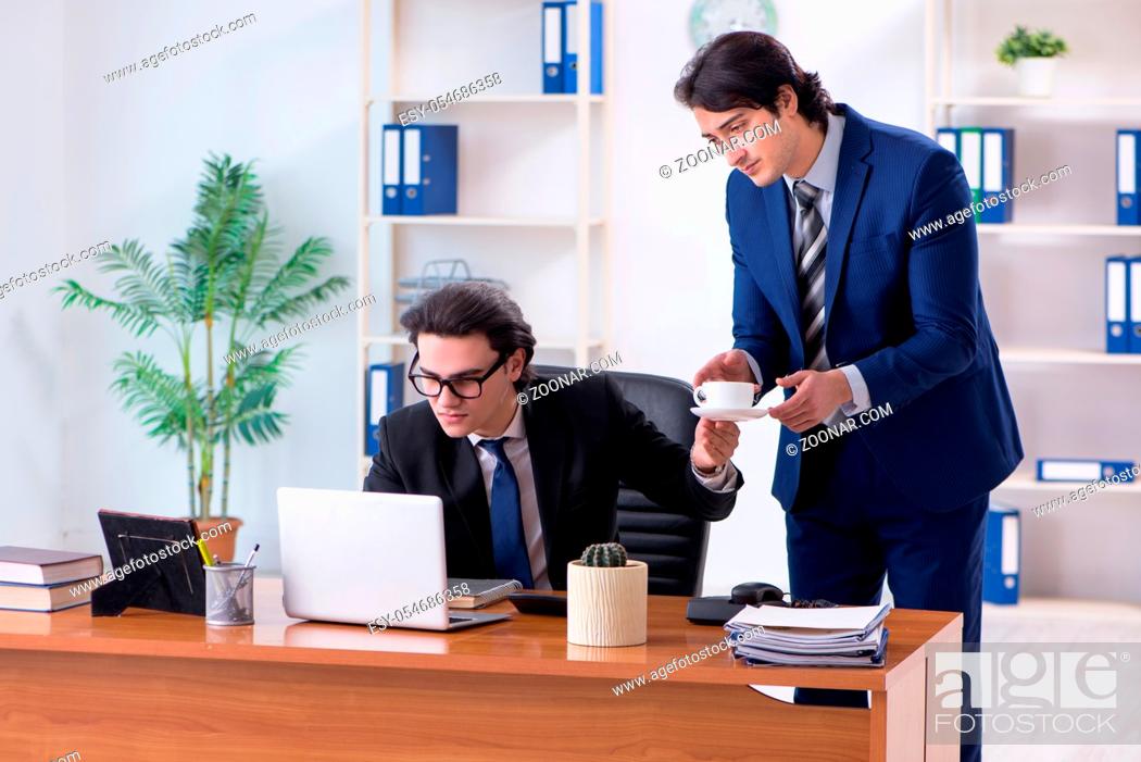 Stock Photo: The boss and his male assistant working in the office.