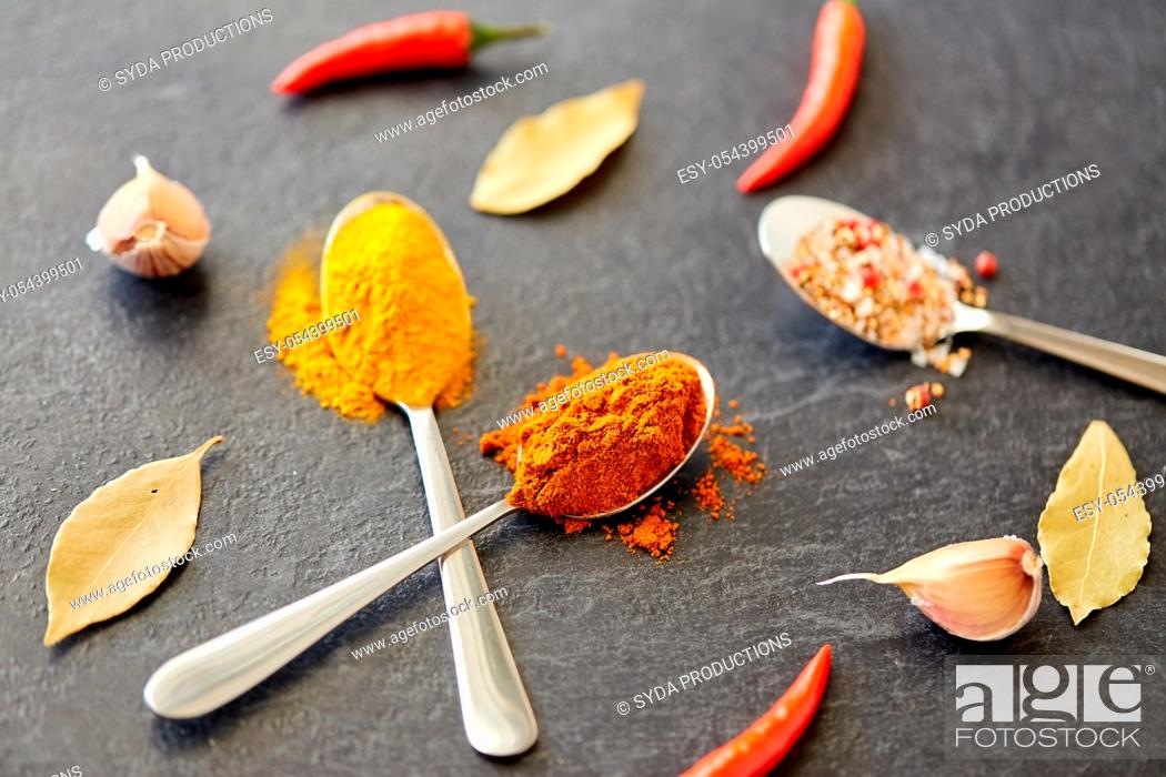 Stock Photo: spices, chili pepper, bay leaf and garlic on stone.