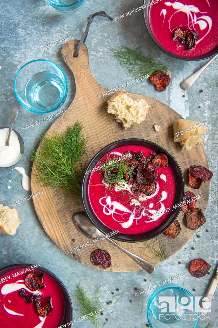 Stock Photo: Beetroot soup with sour cream, beetroot chips and dill.