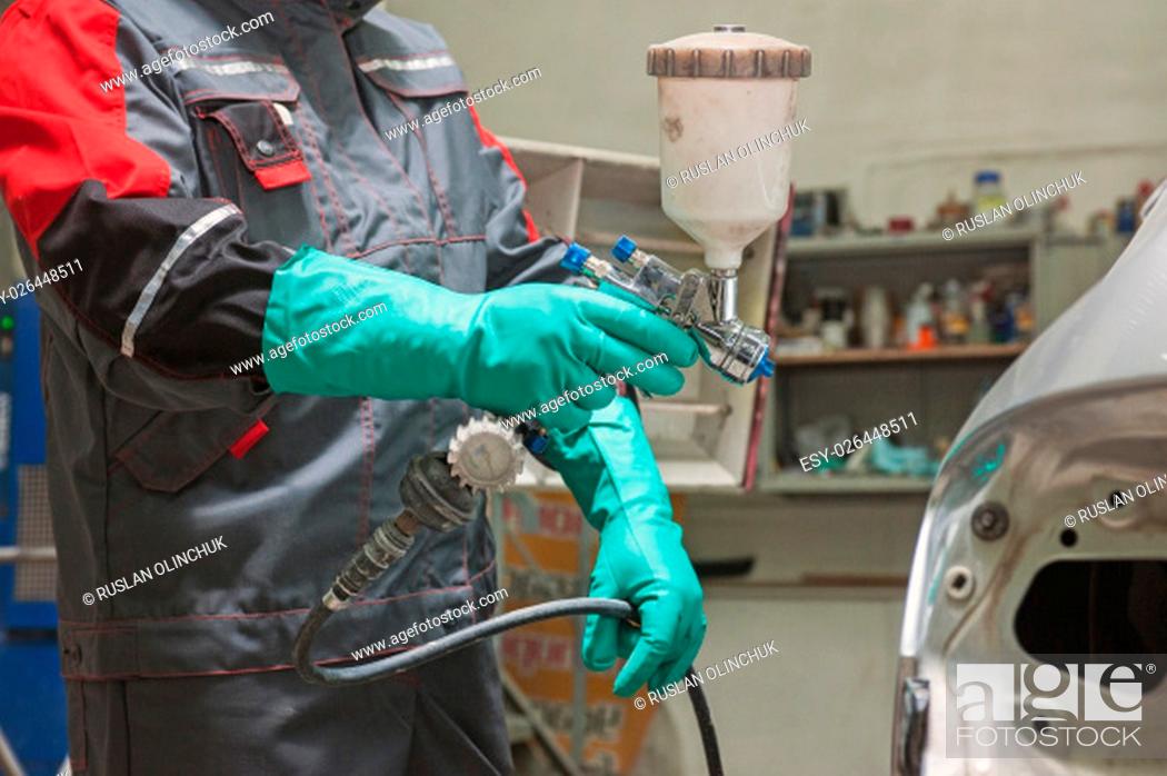 Stock Photo: spray gun with paint for painting a car.