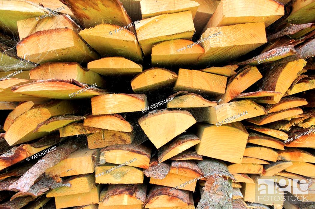 Stock Photo: various wood firewood stacked in a pile.