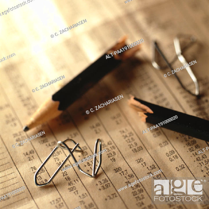 Photo de stock: Broken pencil and twisted paper clips on top of financial numbers.