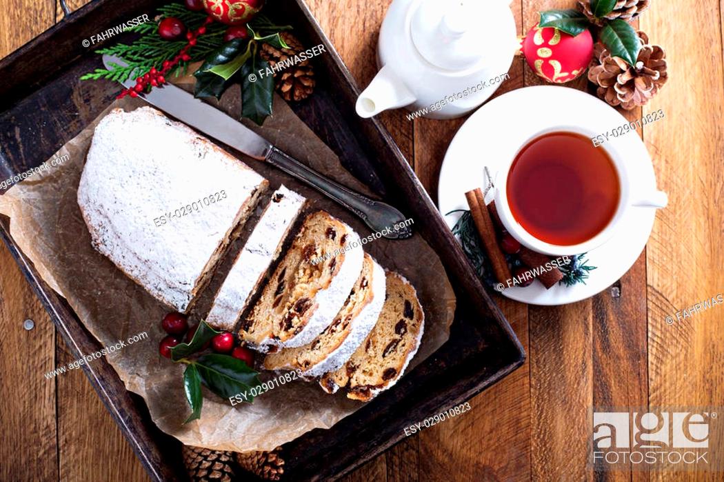 Stock Photo: Christmas stollen with dried fruits and marzipan served with tea and decorations.
