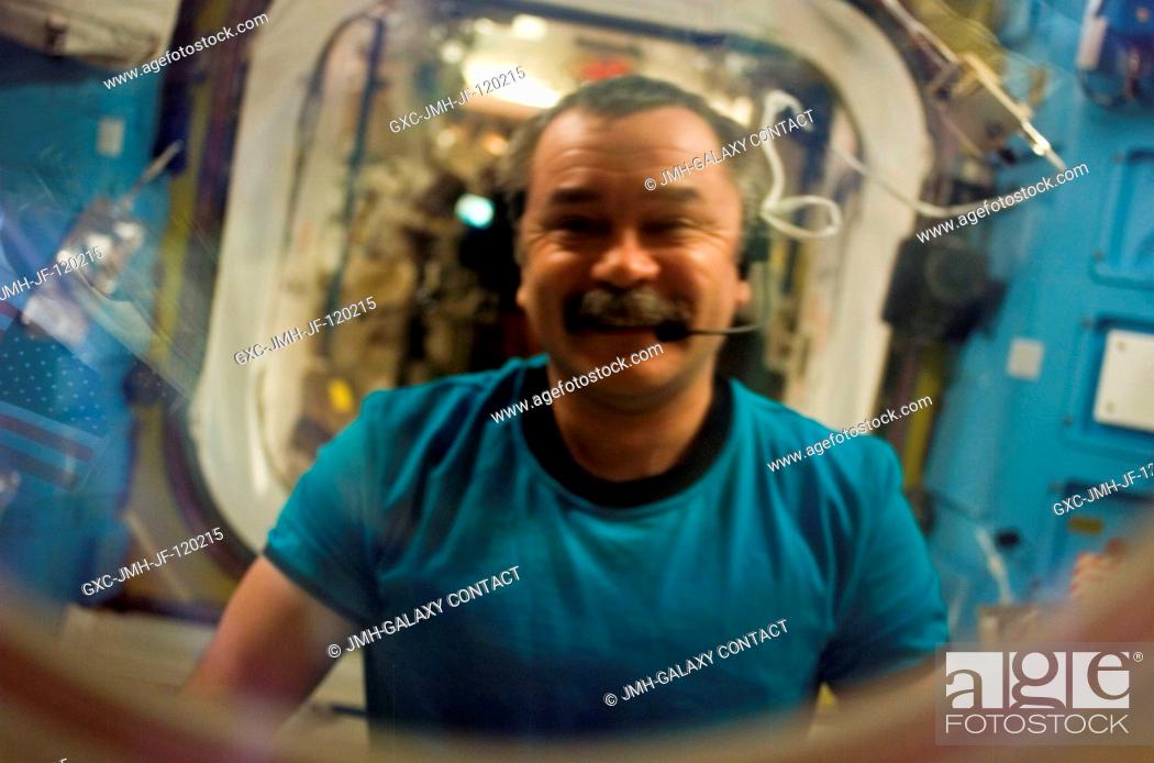 Stock Photo: Cosmonaut Mikhail Tyurin of Russia's Federal Space Agency, Expedition 14 flight engineer, peers out through a hatch window at astronaut Sunita L.