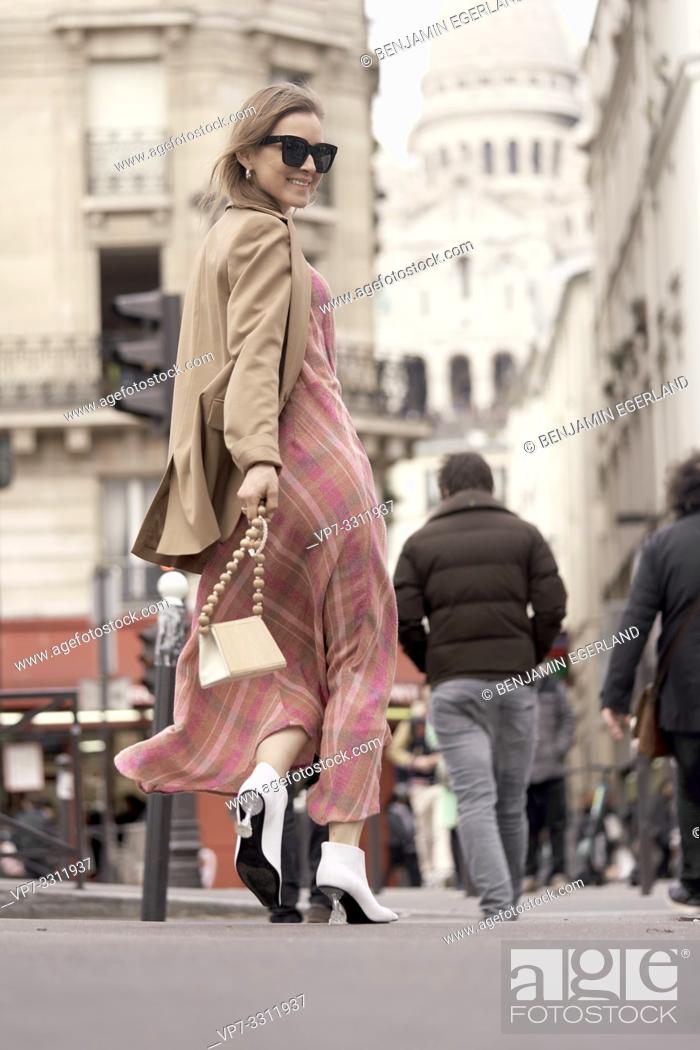 Stock Photo: fashionable blogger woman running at street during fashion week, in front of touristic sight Basilica Sacré-Cœur, in city Paris, France.
