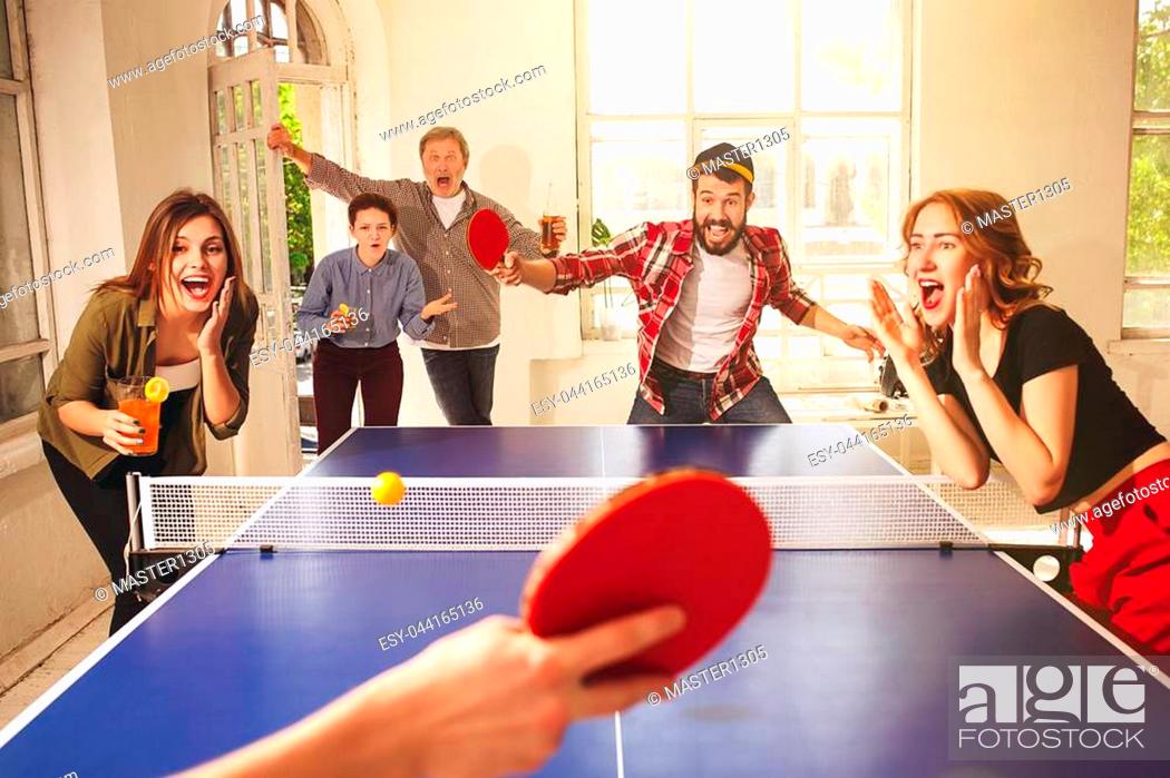 Group of happy young friends playing pong table tennis at office or any room, Stock Picture And Low Budget Royalty Free Image. Pic. ESY-044165136 | agefotostock