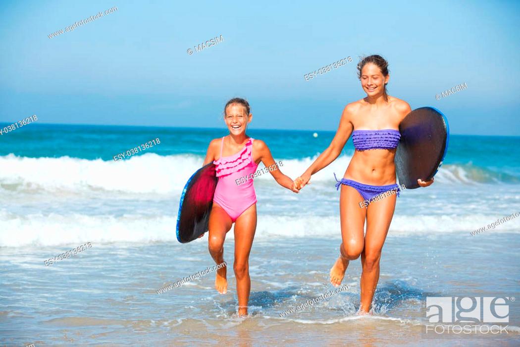 optocht Scepticisme mentaal Summer vacation - Two cute girls in bikini with surfboard running from the  ocean, Stock Photo, Picture And Low Budget Royalty Free Image. Pic.  ESY-038136218 | agefotostock