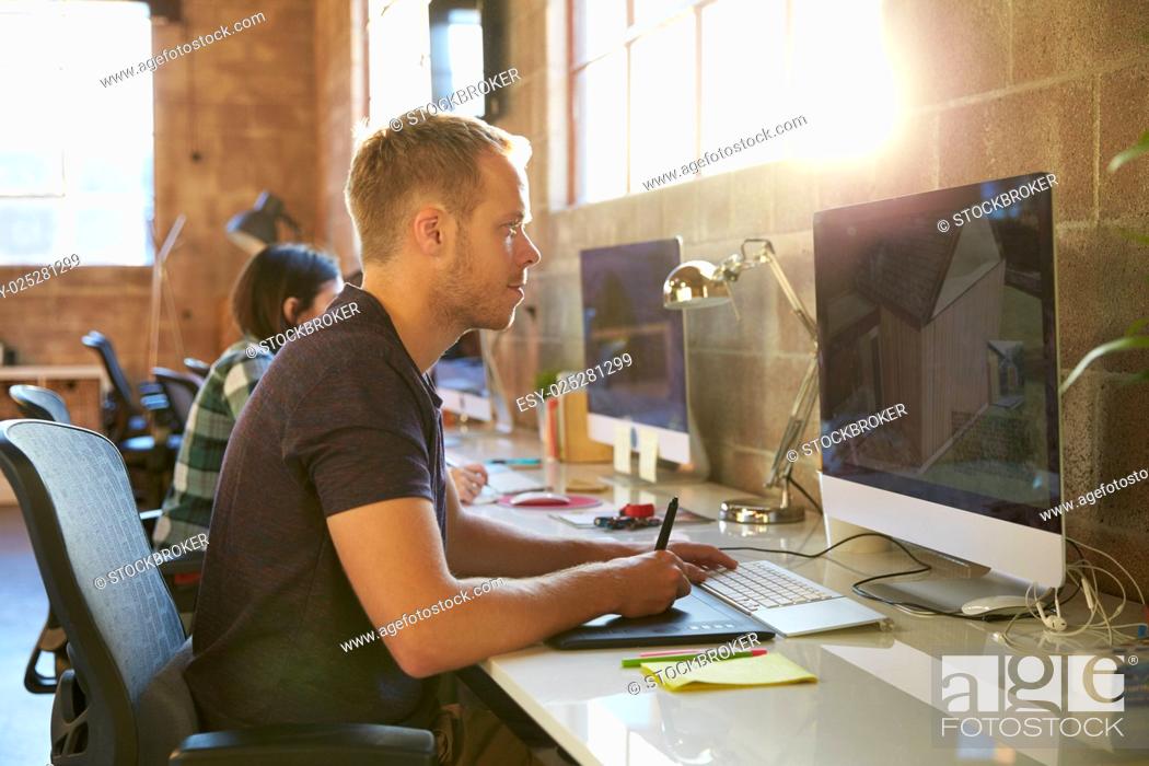 Stock Photo: Designers Working At Desks In Modern Office.