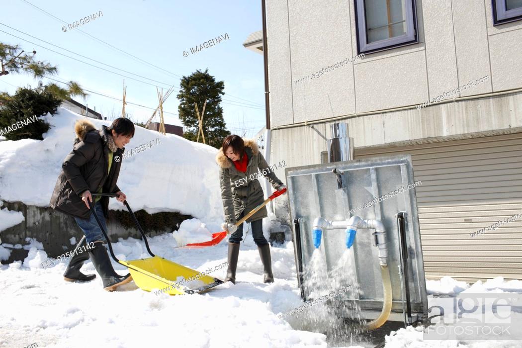 Photo de stock: Couple removing snow.