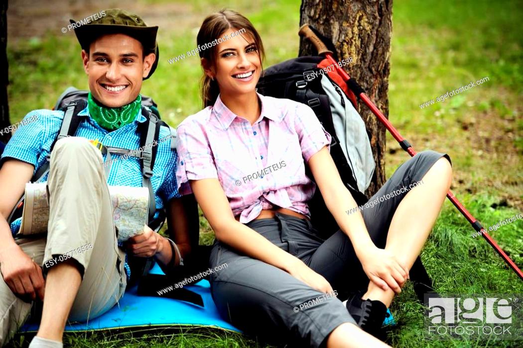 Stock Photo: Hiking couple. Young people makes a hike in the woods. Active lifestyle, tourism. Tourist equipment.