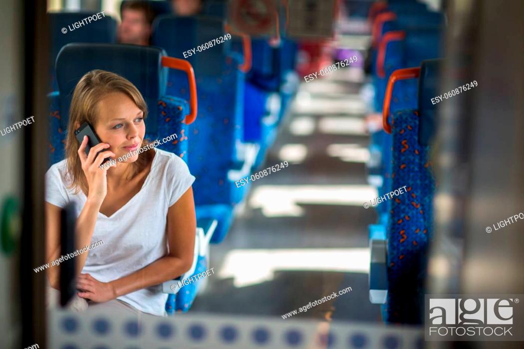 Stock Photo: Young woman sitting in the train after a day of work . Train passenger traveling sitting relaxed and enjoying the ride.