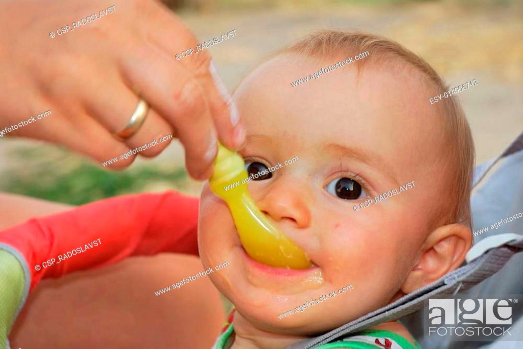 Stock Photo: baby feeding.