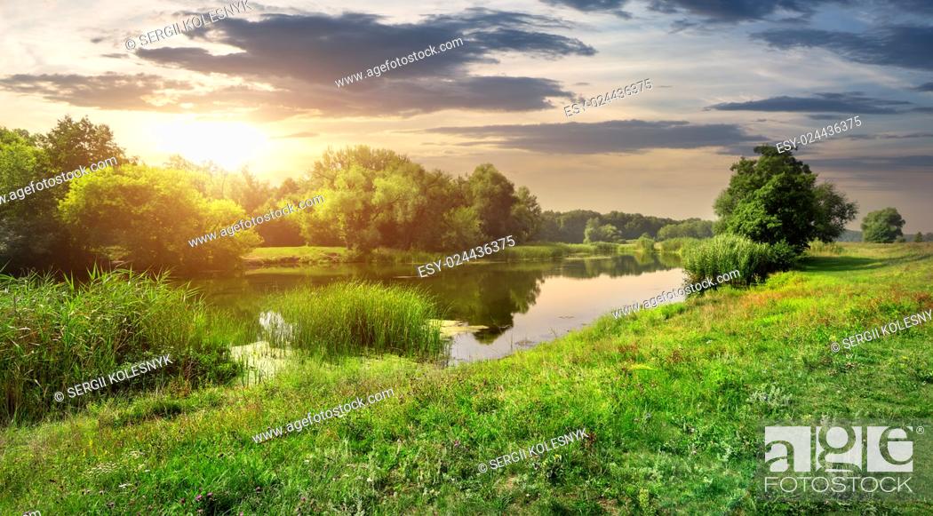 Stock Photo: Sunny sunset over calm river in the forest.