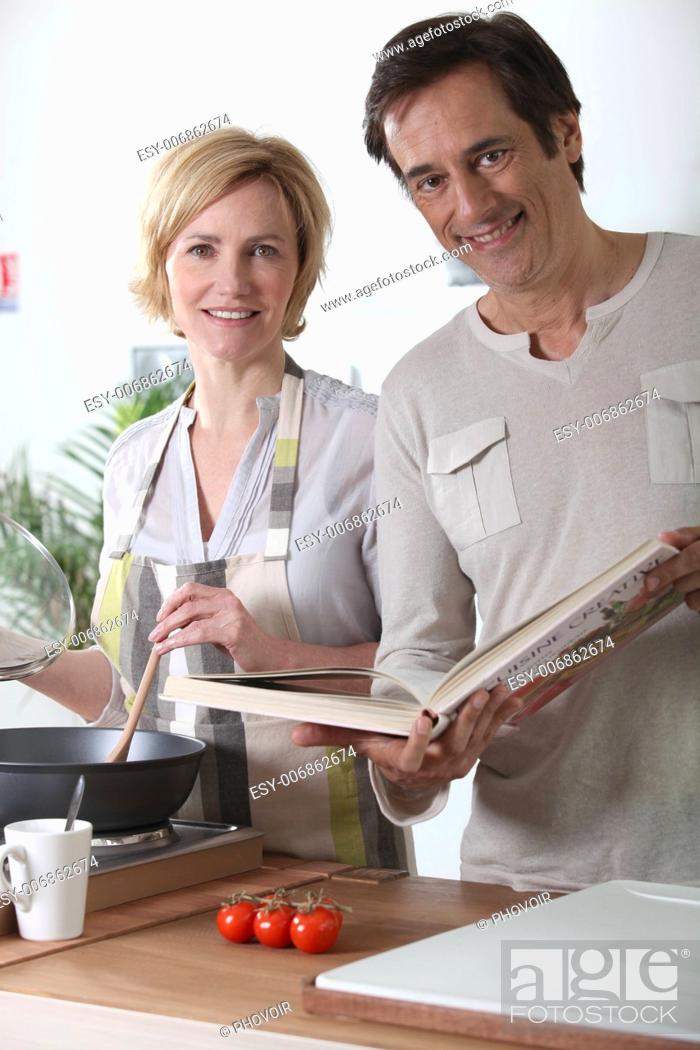 Stock Photo: Couple cooking together in kitchen.