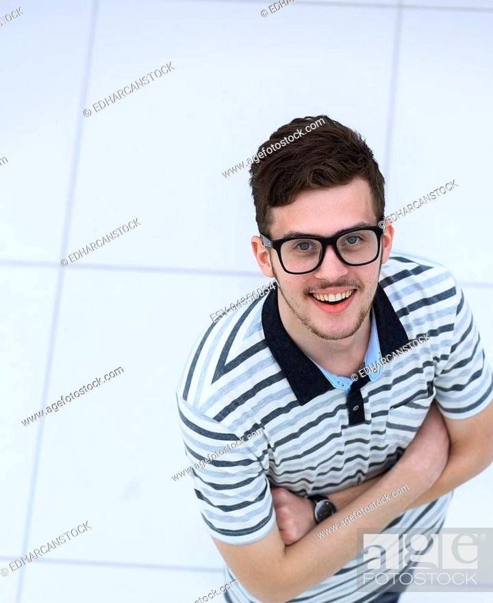 Stock Photo: successful young man with glasses looking at camera. isolated on white background.