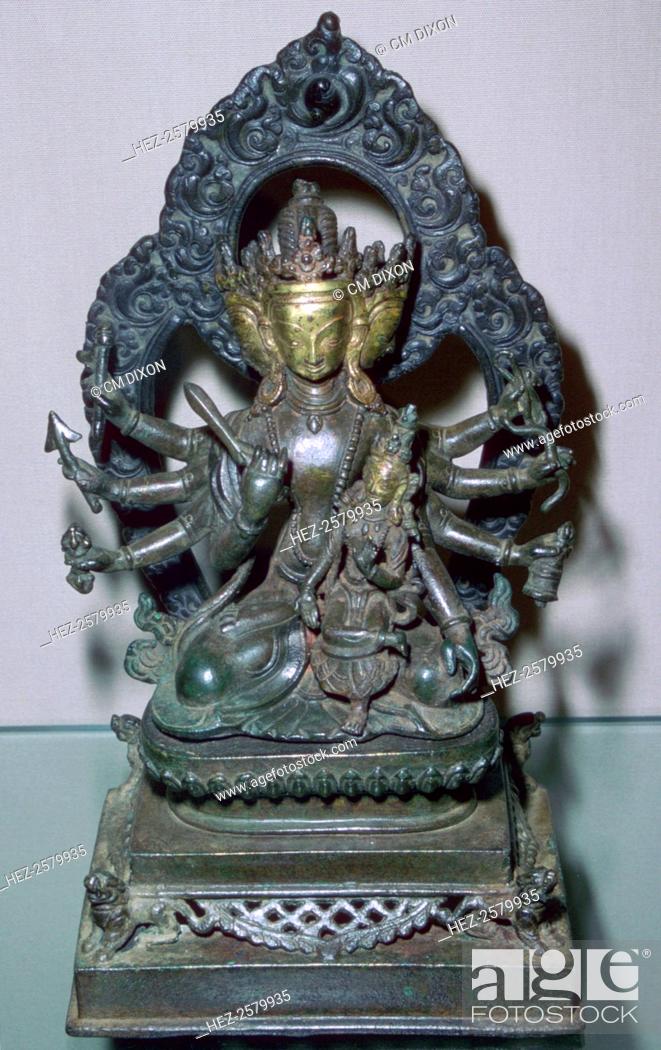 Stock Photo: A bronze statuette of Bodhisattva Manjunatha, a Nepalese deity. The god is holding various emblems and weapons in his many arms, including a Vajra (thunderbolt).