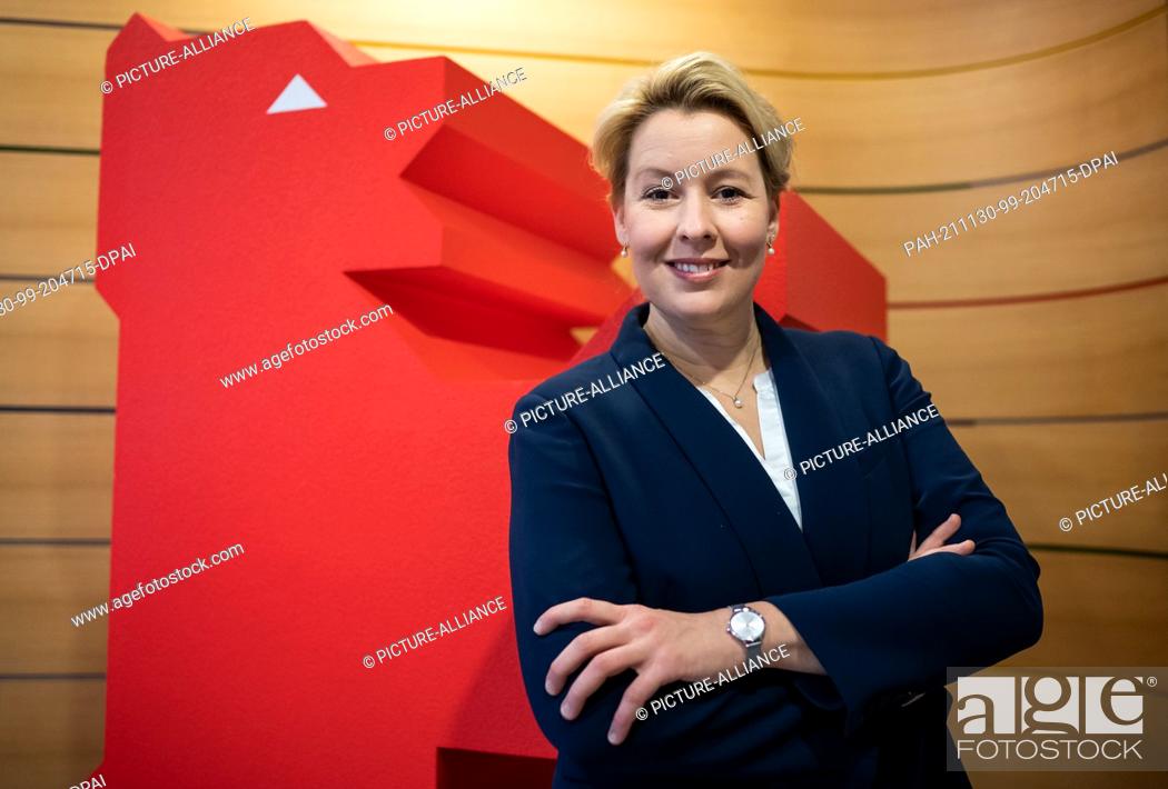 Stock Photo: 30 November 2021, Berlin: Franziska Giffey, chairwoman of the Berlin SPD and designated governing mayor of Berlin, stands in front of a red bear during an.