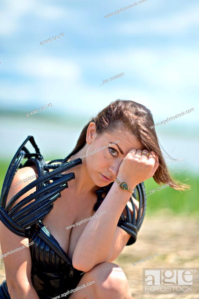 Stock Photo: Woman dressed up with a futuristic space look costume holding a rusty trident, creating a modern interpretation of Salacia, Neptune's queen.