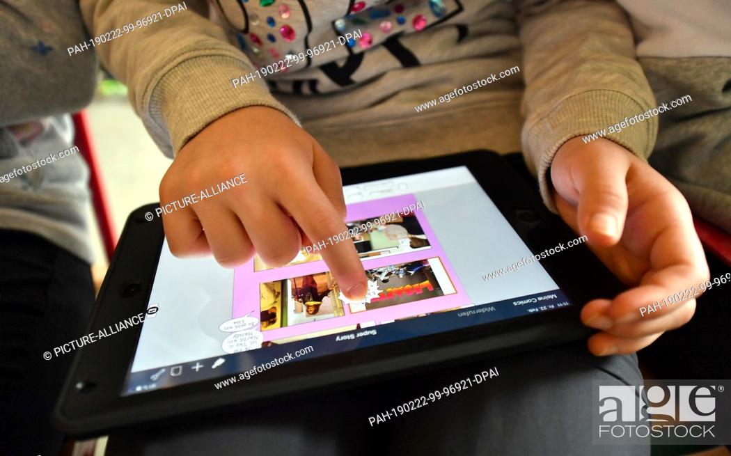 Stock Photo: 22 February 2019, Thuringia, Erfurt: A pupil of the Schillerschule works with a tablet. The pupils of two sixth grades take part in the media competence course.