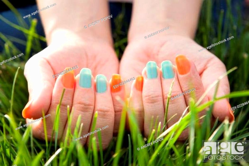 Stock Photo: Close Up Of Woman's Finger On Grass.