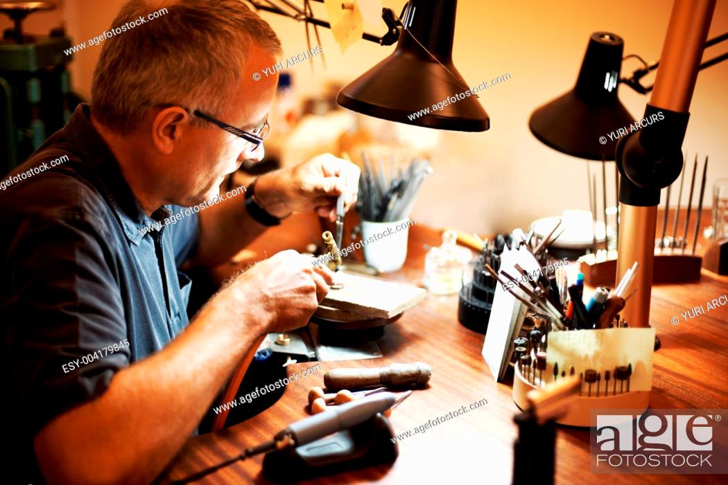 Stock Photo: Jeweler using a blowtorch while working.