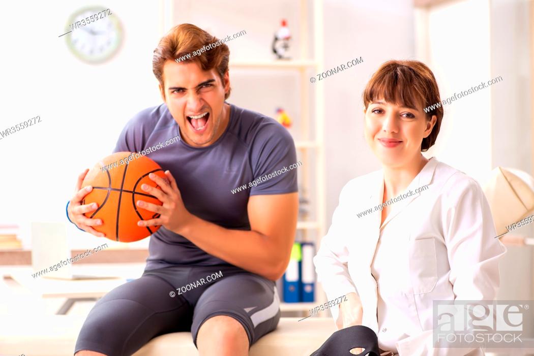 Stock Photo: Handsome basketball player visiting female doctor traumatologist.