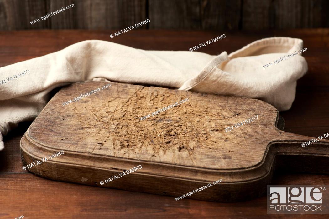 Stock Photo: empty brown very old vintage kitchen cutting board with handle, place for an inscription.