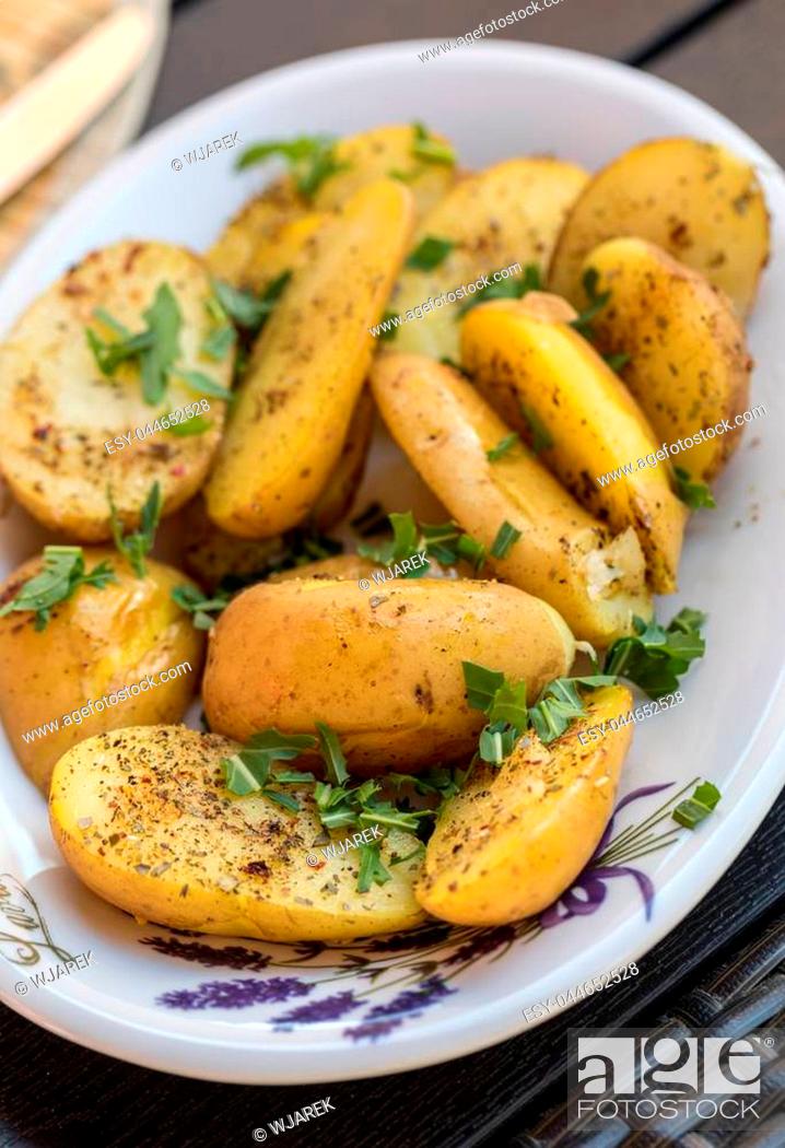 Stock Photo: potatoes with herbs sprinkled with green parsley.