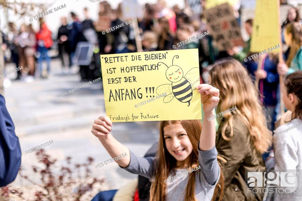 Stock Photo: Girl holding a placard on a demonstration for environmentalism.