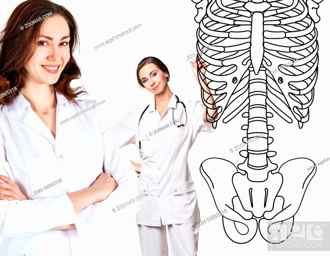 Stock Photo: Medical doctor woman pointing on drawing human skeleton, isolated on white.