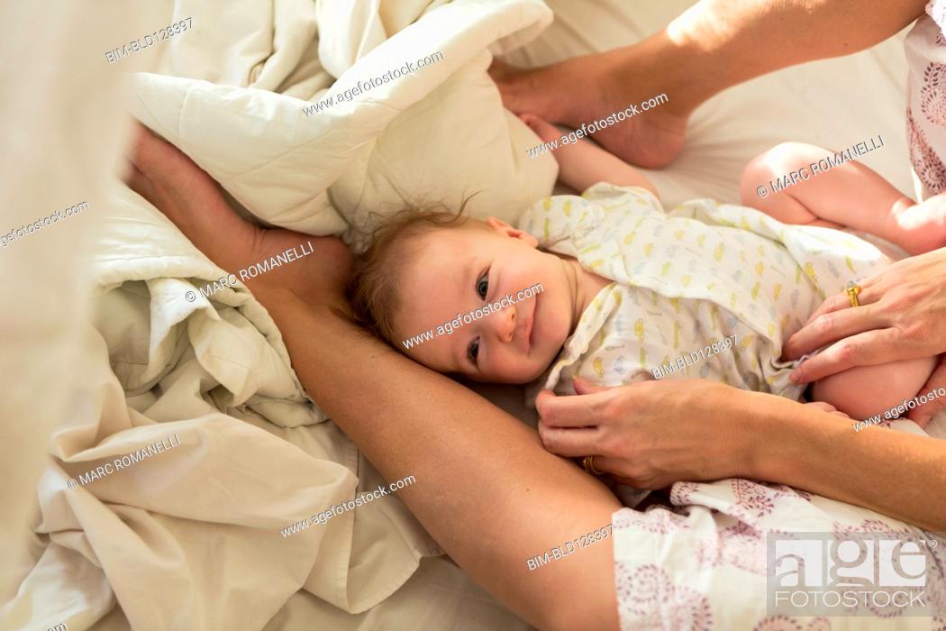 Stock Photo: Caucasian mother and baby boy laying in bed.
