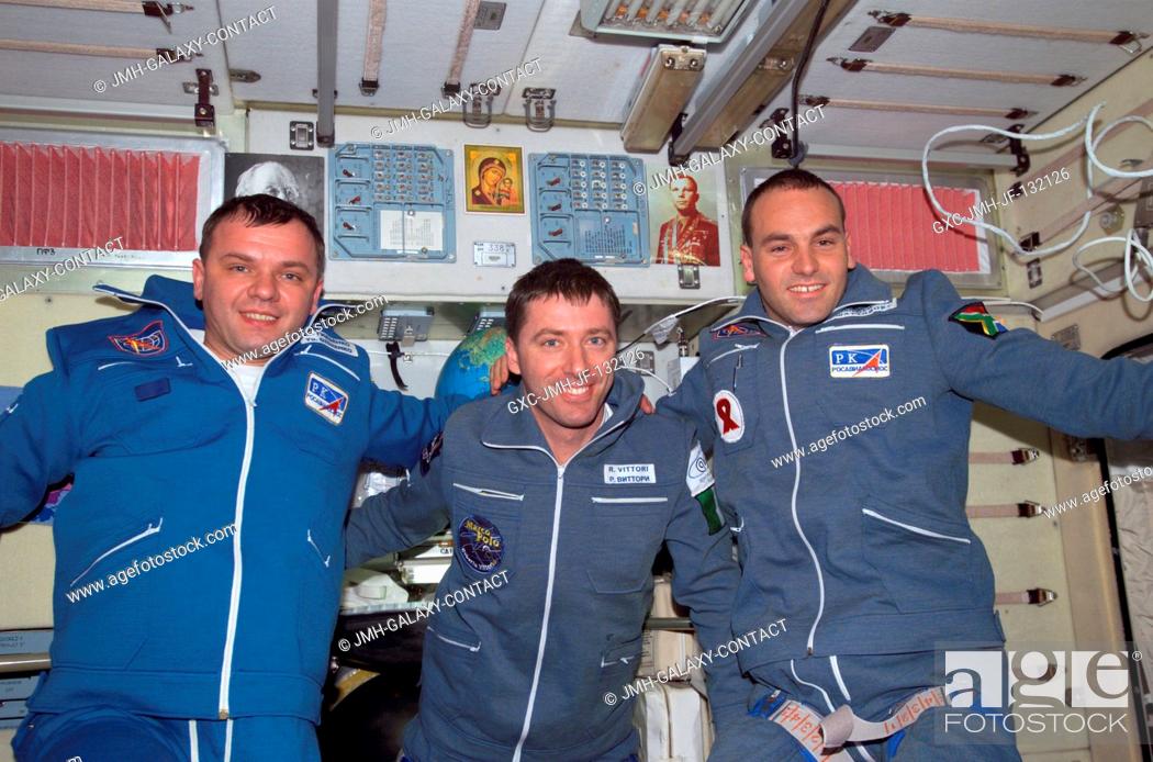 Stock Photo: The Soyuz Taxi crewmembers pose for a group photo in the Zvezda Service Module on the International Space Station (ISS). From the left are Commander Yuri.