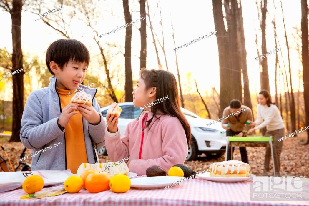 Stock Photo: Happy family outdoor barbecues.