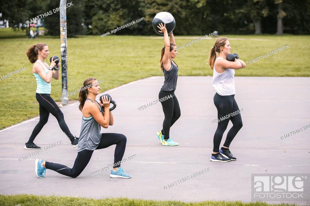 Stock Photo: Four women having an outdoor boot camp workout.