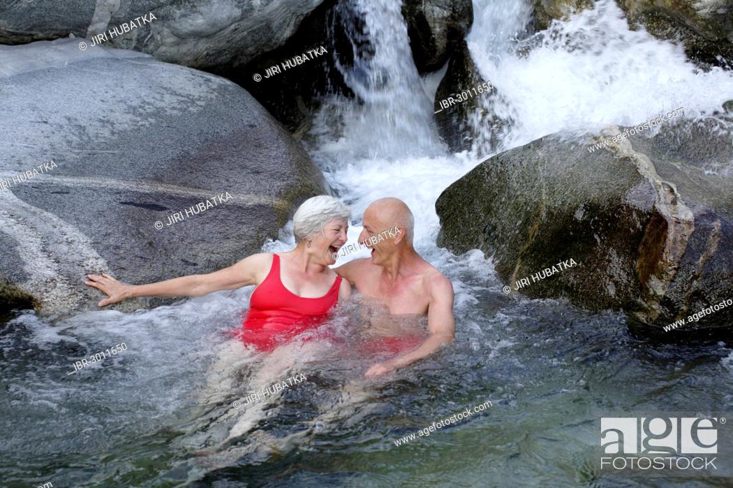 Stock Photo: Couple, 59 and 68 years, bathing in the mountain river of Torrente Codera.