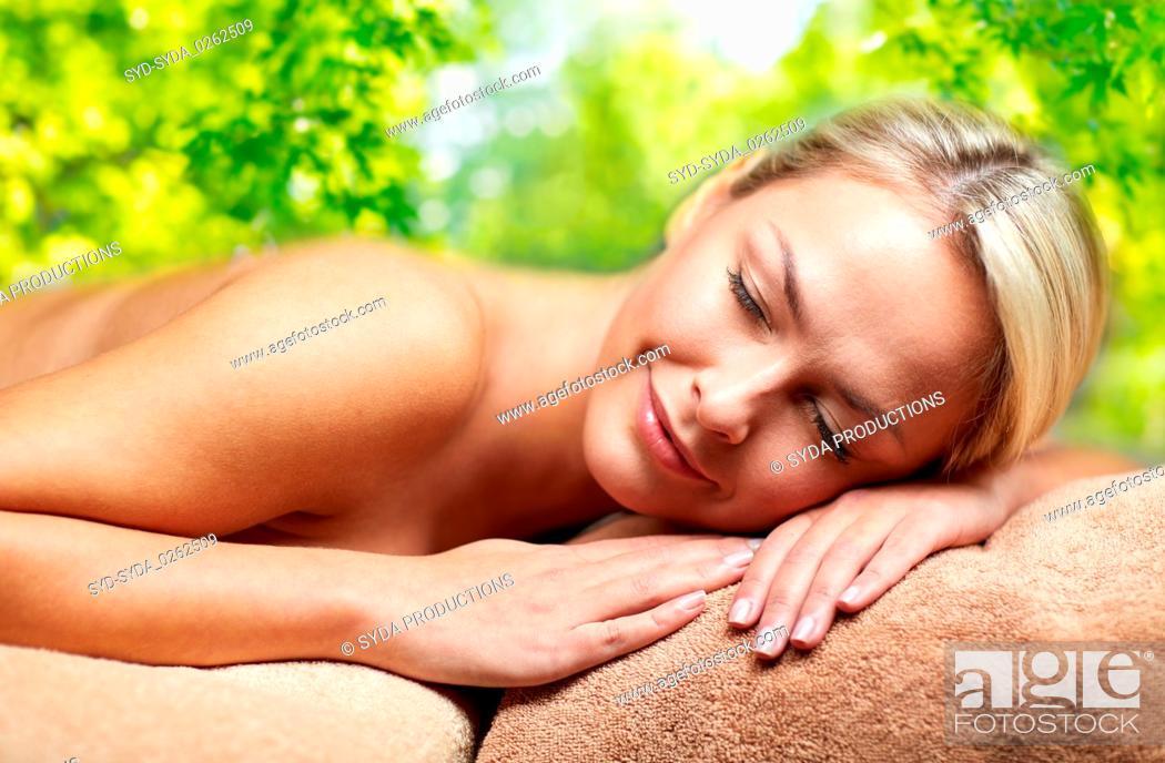 Photo de stock: young woman lying on massage table in spa.