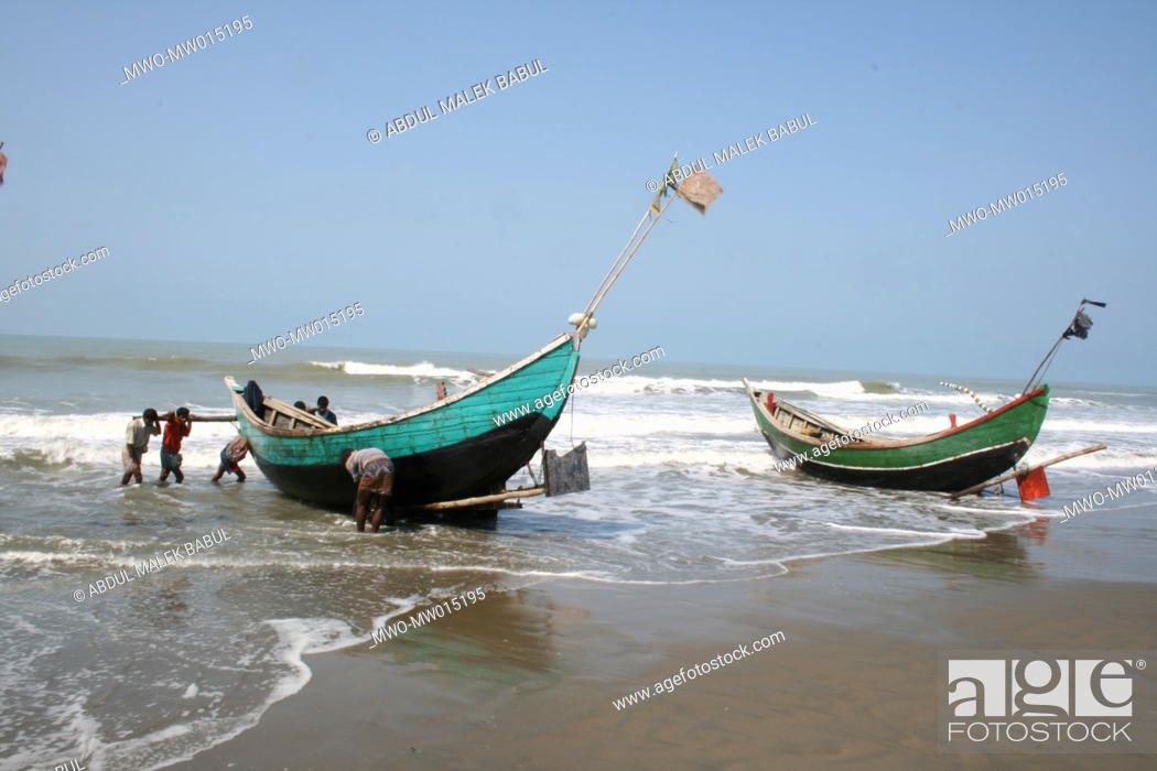 Stock Photo: Fishermen bringing their boat to the shore, at Shah Porir Island, Teknaf, Cox’s Bazar, Bangladesh March 22, 2008.
