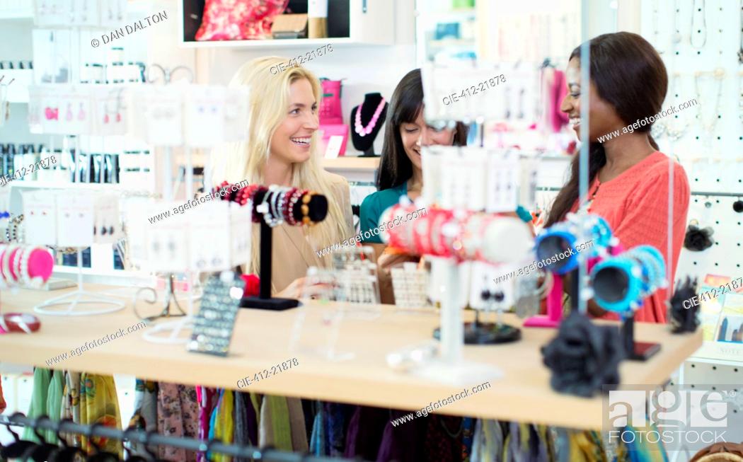 Stock Photo: Women shopping together in clothing store.