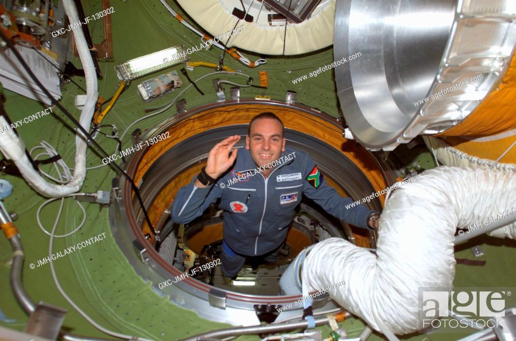 Stock Photo: South African space flight participant Mark Shuttleworth enters the functional cargo block's (FGB) pressurized adapter on the International Space Station (ISS).