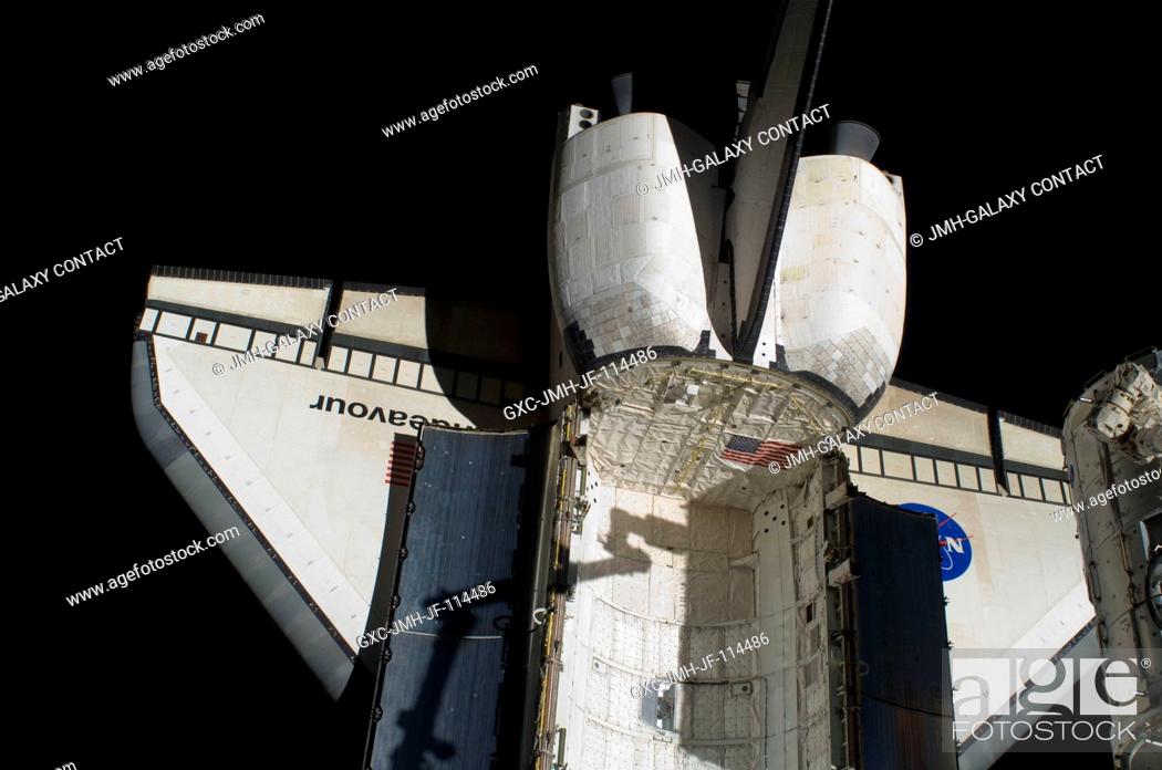 Stock Photo: Space shuttle Endeavour's aft payload bay, orbital maneuvering system (OMS) pods, vertical stabilizer and wings are featured in this image photographed by an.