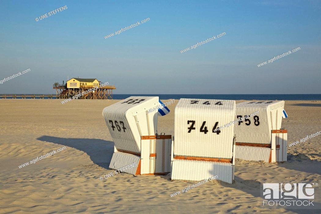 Stock Photo: Morning on the Große Sandbank in front of Sankt Peter-Ording, beach chairs with the pile dwelling of the Cafe'54 Grad,.