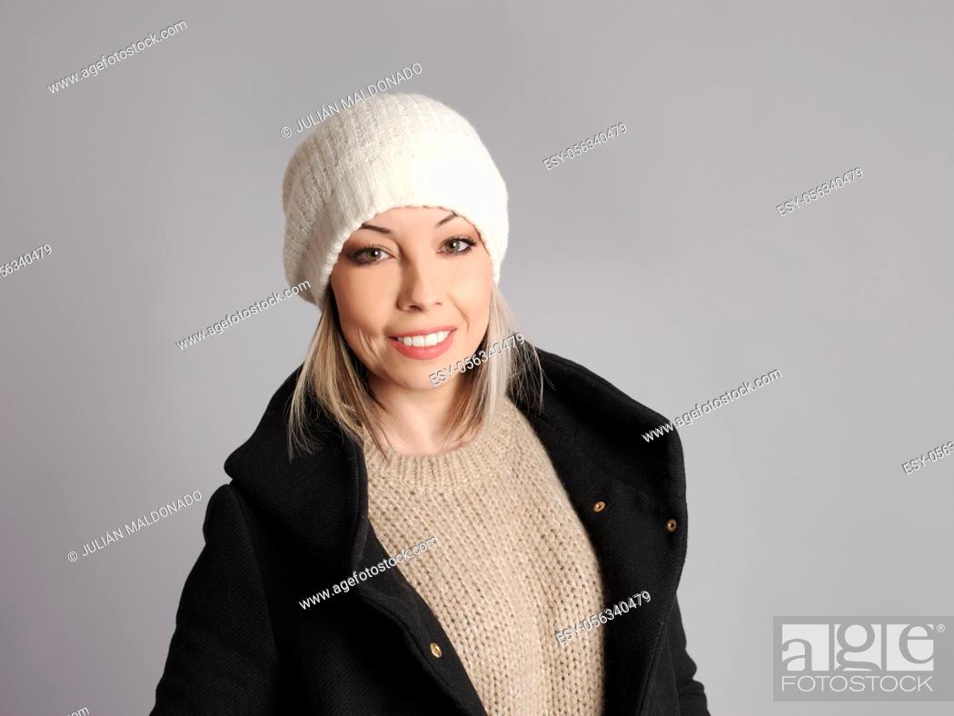 Stock Photo: Pretty young woman poses with cheerful and friendly winter and fitness clothes.